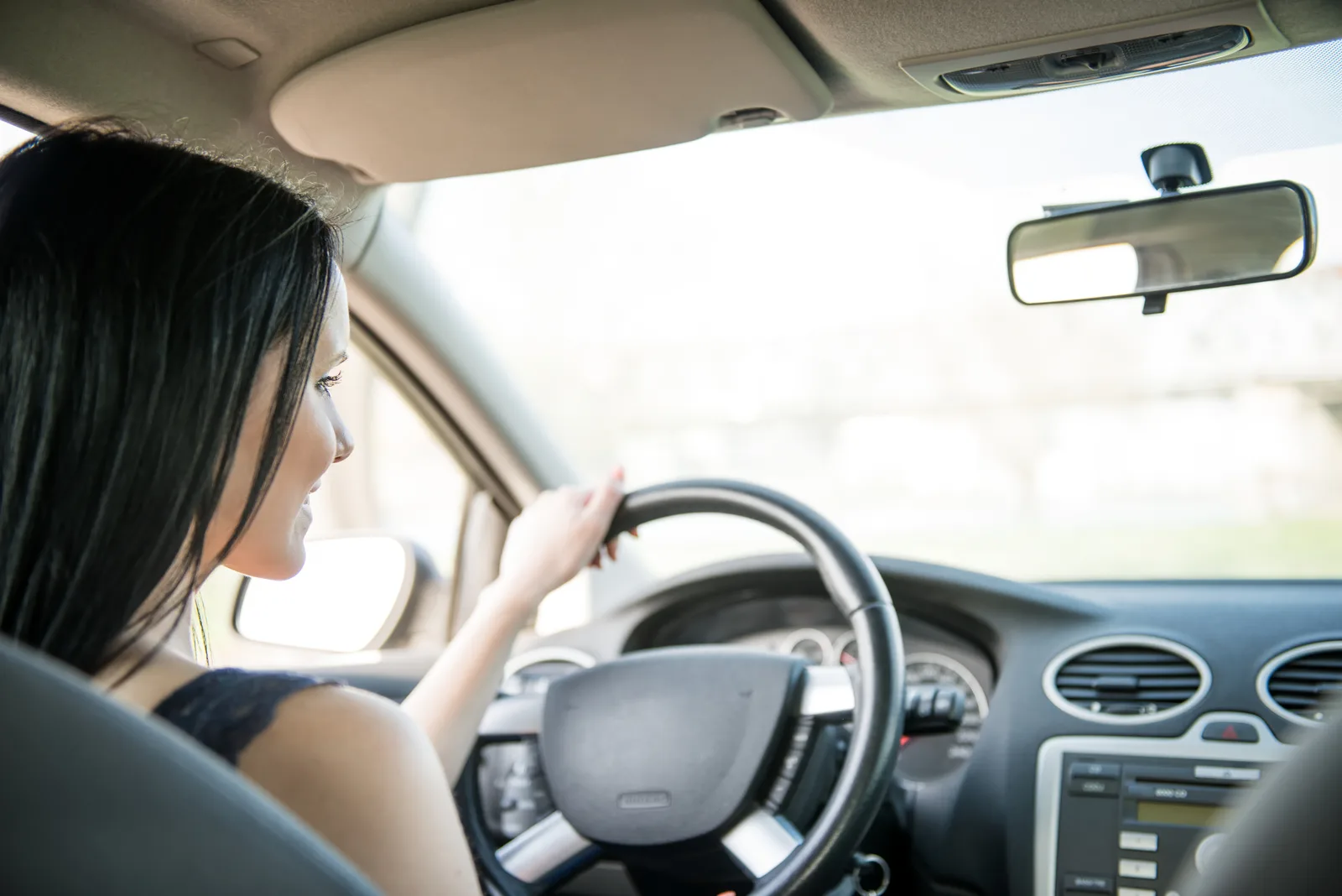 New driver holding out car keys after completing driver education